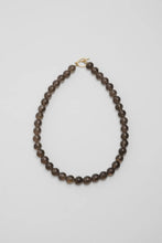 Load image into Gallery viewer, Beaded necklace on a light grey background