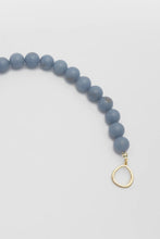 Load image into Gallery viewer, Blue beaded necklace with a gold clasp on a light gray background