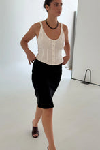 Load image into Gallery viewer, Woman wearing a brown beaded necklace and white sleeveless top and black skirt against a plain background