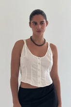 Load image into Gallery viewer, Woman wearing a brown beaded necklace and white sleeveless top and black skirt against a plain background