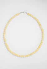 Load image into Gallery viewer, A single-strand beaded necklace made of pale yellow round beads with a silver lobster clasp, displayed on a clean white background.