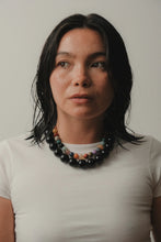 Load image into Gallery viewer, Woman wearing a colorful beaded necklace against a plain background