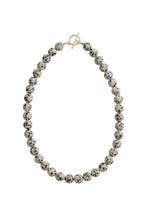 Load image into Gallery viewer, Necklace with beige and black beads and a gold clasp on a white background