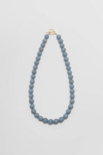 Load image into Gallery viewer, Blue beaded necklace with a gold clasp on a light gray background
