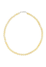 Load image into Gallery viewer, A delicate beaded necklace made of small, pale yellow round beads with a silver lobster clasp, displayed on a clean white background.
