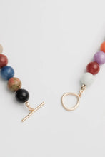 Load image into Gallery viewer, Multicolored beaded necklace with gold clasp on a light grey background
