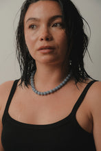 Load image into Gallery viewer, Woman wearing a black tank top and grey beaded necklace against a neutral background
