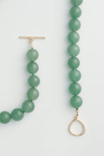 Load image into Gallery viewer, Green beaded necklace with gold clasp on a light gray background
