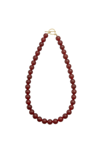 Red beaded necklace on a white background